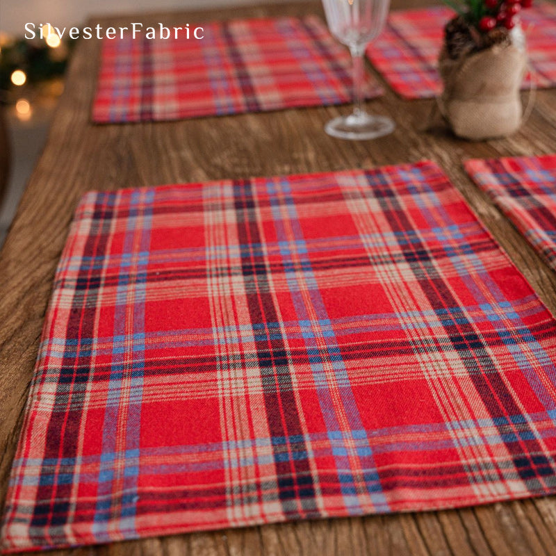 red Christmas plaid placemats laid flat on dining table
