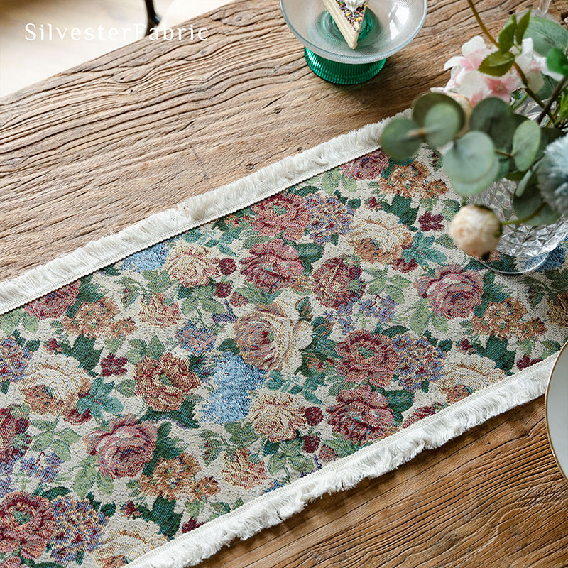 A floral table runner is placed on the table
