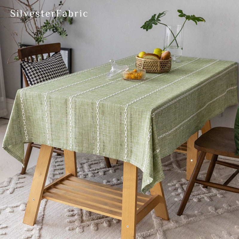 Close-up of a stripes embroidered green tablecloth