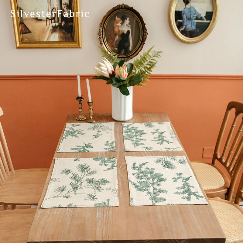 green farmhouse botanical placemats laid flat on dining table