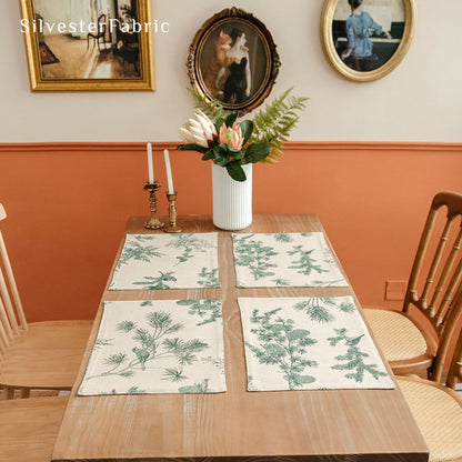 green farmhouse botanical placemats laid flat on dining table