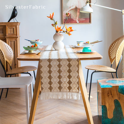 A beige boho crochet table runner on the table