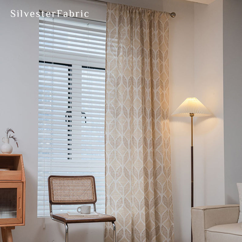 Beige printed linen curtains hang in the bedroom window.