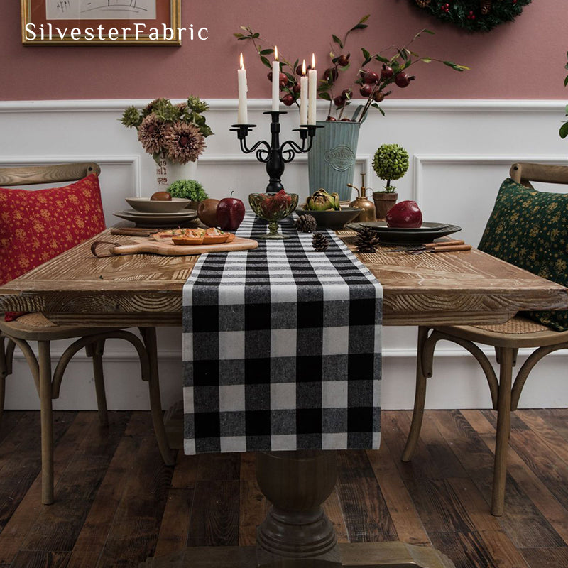 Black and white plaid table runner spread on wooden table