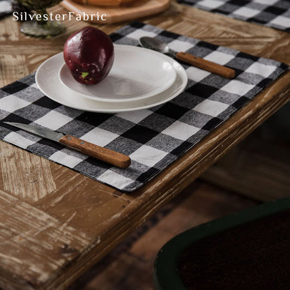 Black and white plaid table runner spread on wooden table