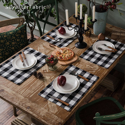 Black and white plaid table runner spread on wooden table