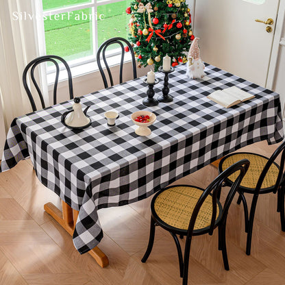Black and White Christmas Buffalo Check Tablecloth draped over rectangle table