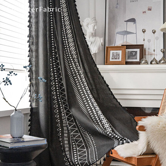 Black linen curtains hanging in the window