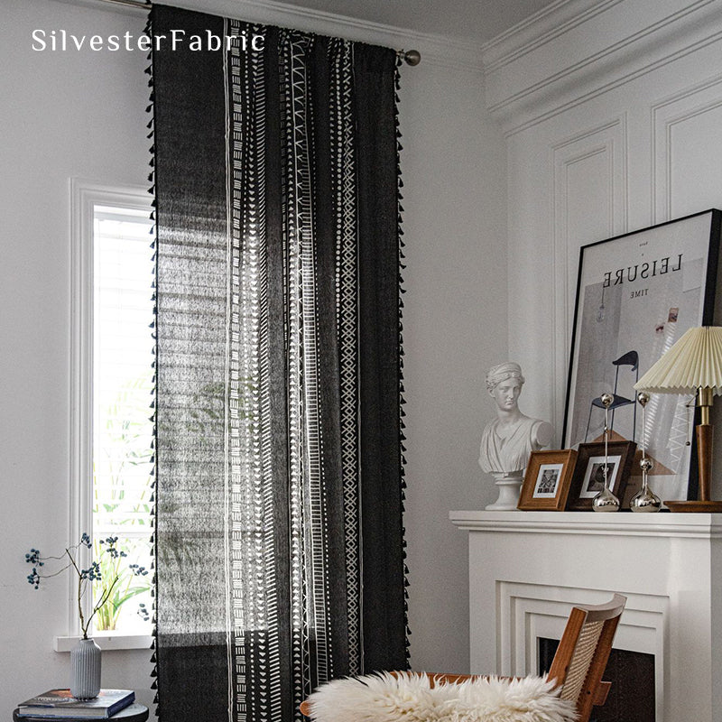 Black linen curtains hanging in the window