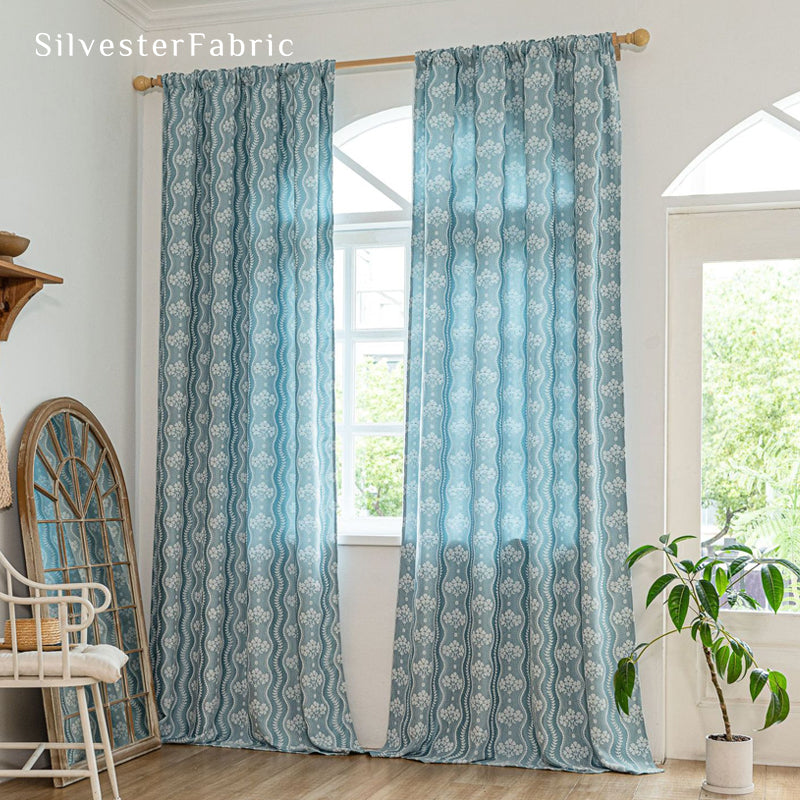 blue floral farmhouse curtain hanging in window