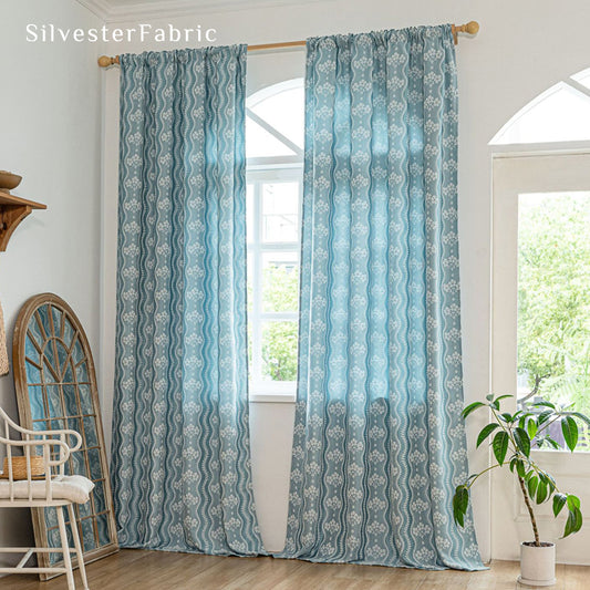 blue floral farmhouse curtain hanging in window