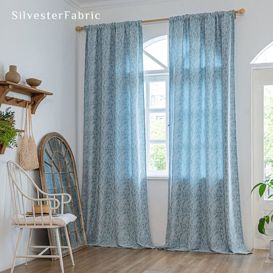 blue paisley bohemian curtain hanging in window