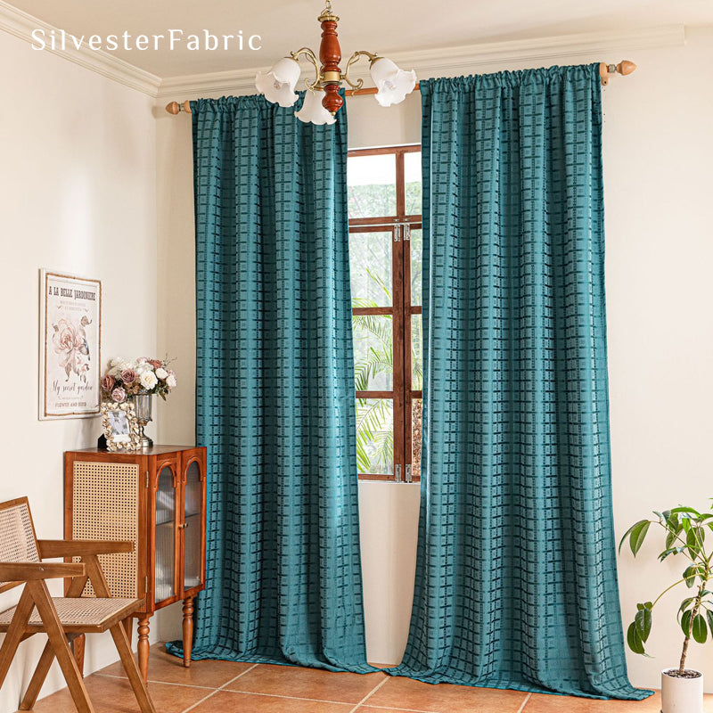 Blue jacquard farmhouse curtain hanging in window