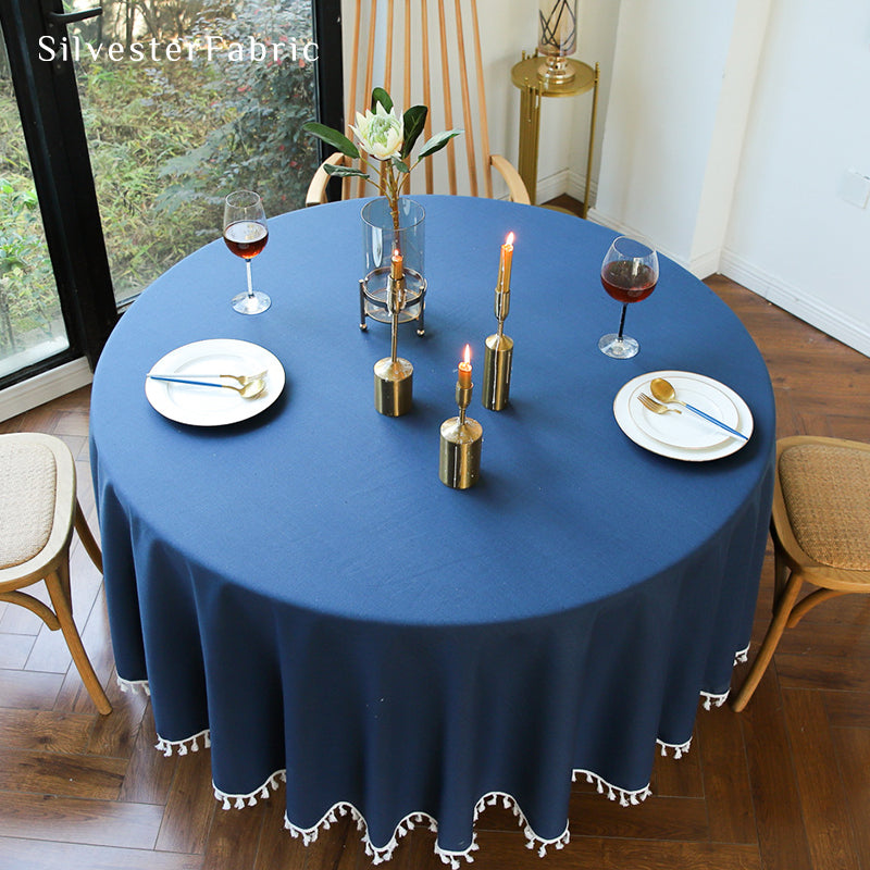 A round blue tablecloth covers the table