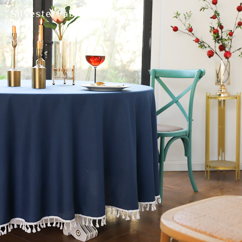 A round blue tablecloth covers the table