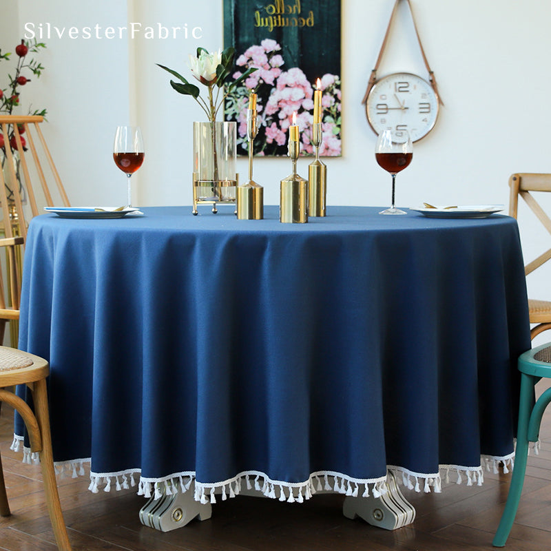 A round blue tablecloth covers the table