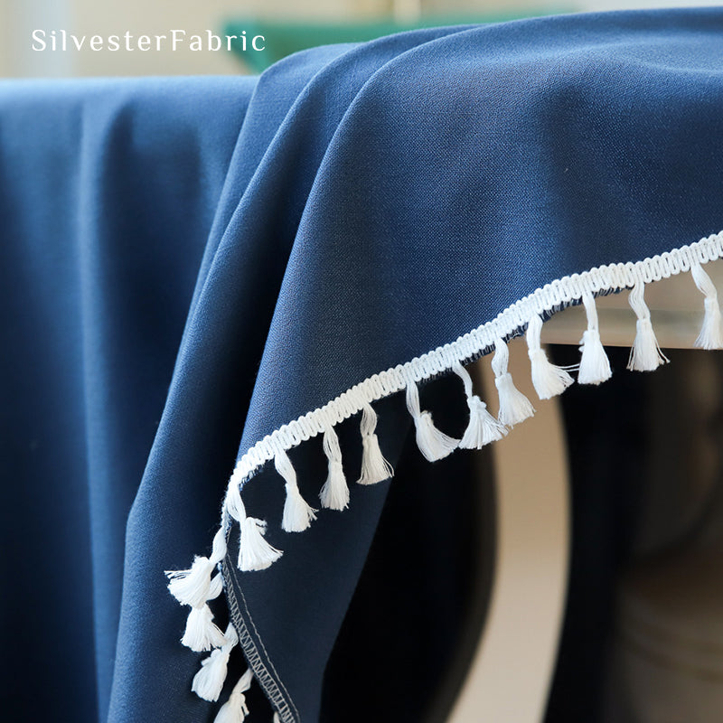 A round blue tablecloth covers the table