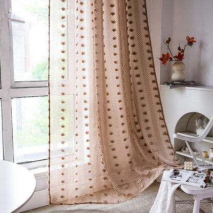 Brown sheer curtains hanging in the bedroom window