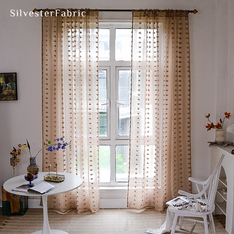 Brown sheer curtains hanging in the bedroom window