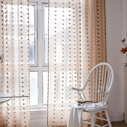 Brown sheer curtains hanging in the bedroom window