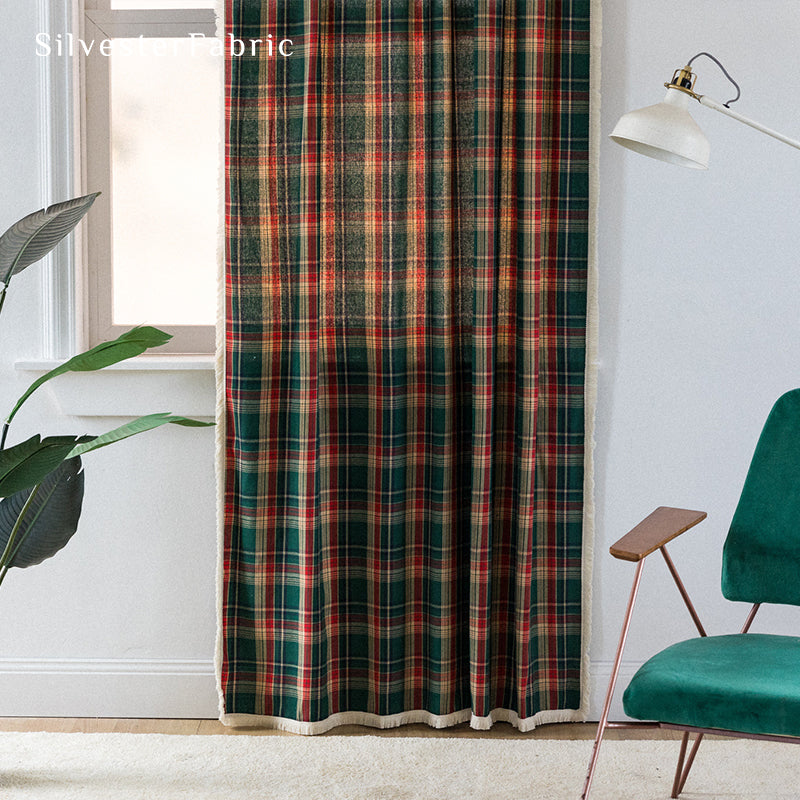 Green plaid Christmas curtains hanging in the living room window