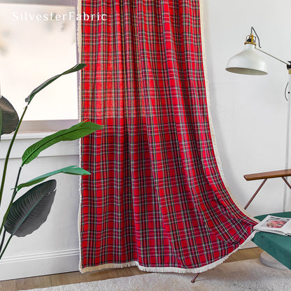 Red Christmas plaid curtains hanging in the living room window