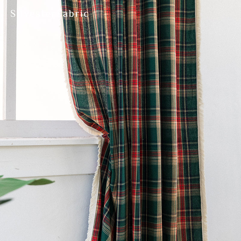 Green plaid Christmas curtains hanging in the living room window