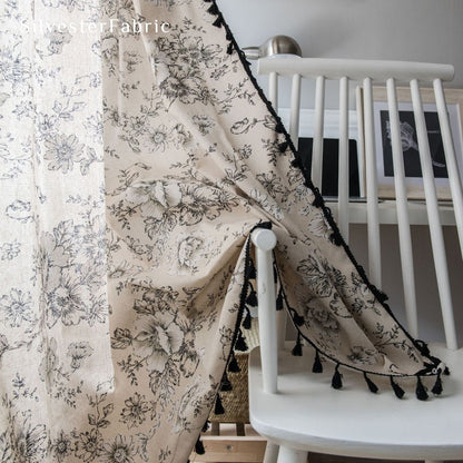 Black floral curtains hanging in the bedroom window