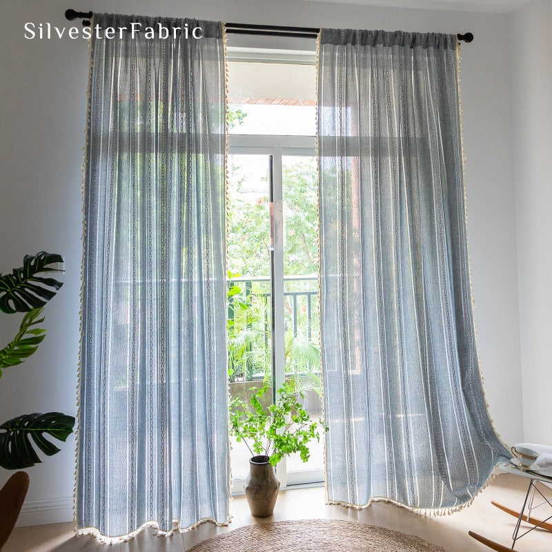 Light blue curtains hanging in the bedroom window