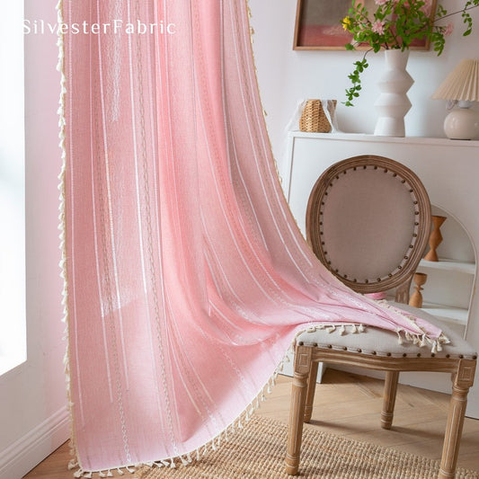 light pink curtains hanging in the bedroom window