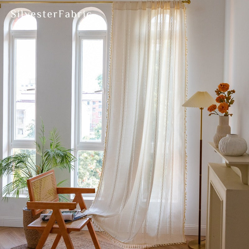 Elegant off white curtains hang on your bedroom window