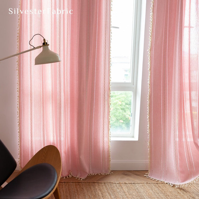 Pink curtains hung in the bedroom window