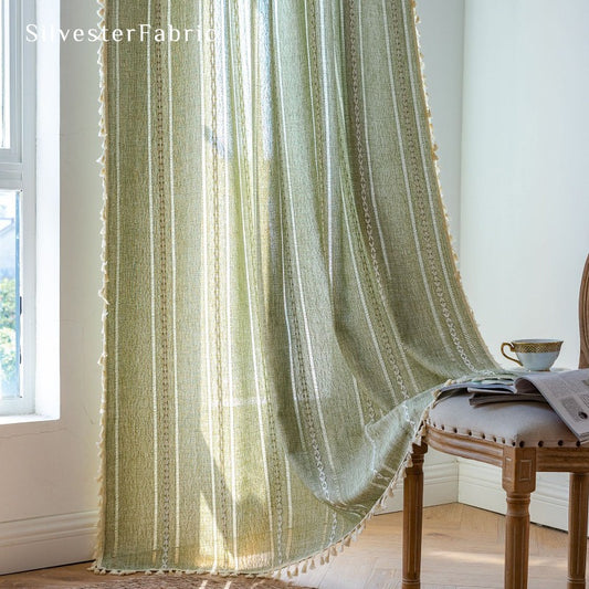 Sage green curtains hanging in the living room window