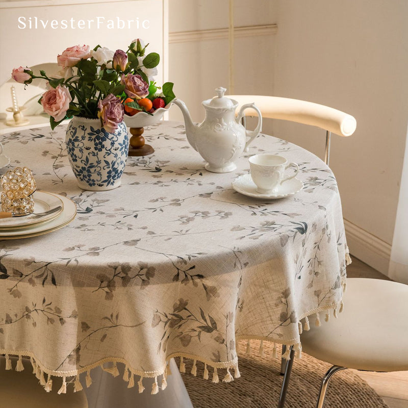 farmhouse floral tablecloth draped over round table