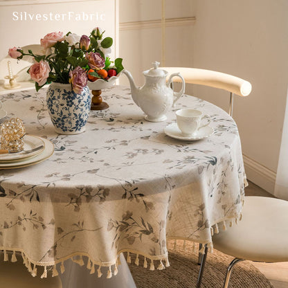 farmhouse floral tablecloth draped over round table