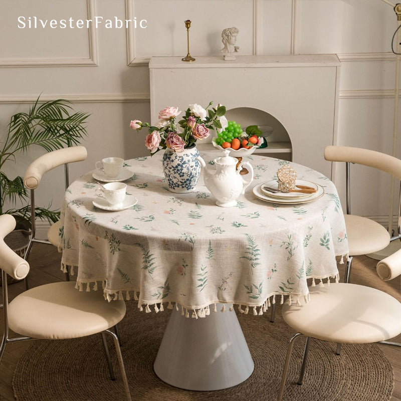 floral farmhouse tablecloth draped over round table