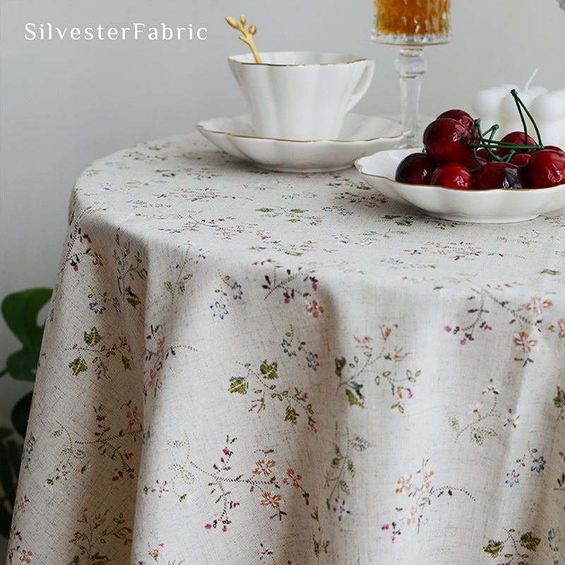 Square floral linen tablecloth on a round table