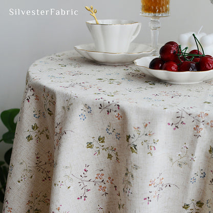 Square floral linen tablecloth on a round table