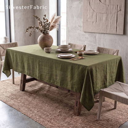 solid green tablecloth draped over rectangle table