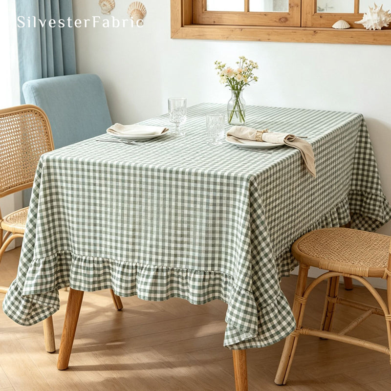 green plaid farmhouse tablecloth laid flat on dining table