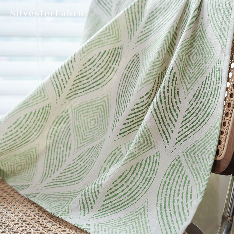 Green sheer curtains hang from the windows and flutter in the wind.