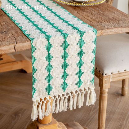 Green table runner in the centre of a wooden table