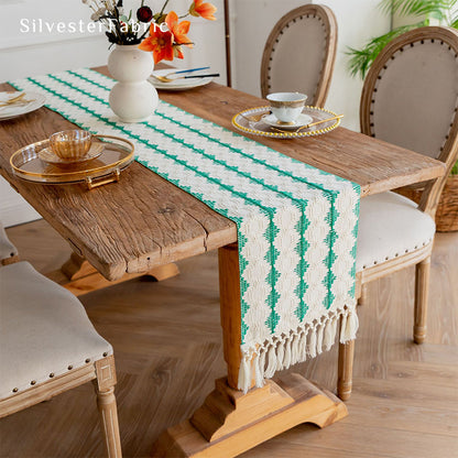 Green table runner in the centre of a wooden table