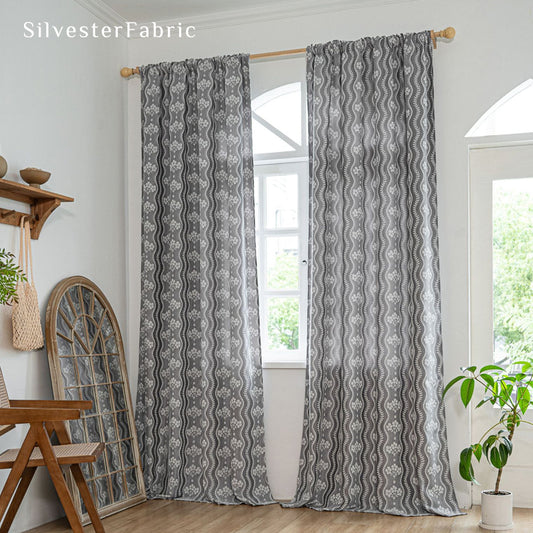 grey floral farmhouse curtain hanging in window