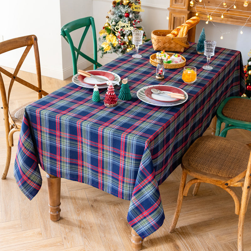 blue Christmas tartan plaid cotton tablecloth draped over rectangle table