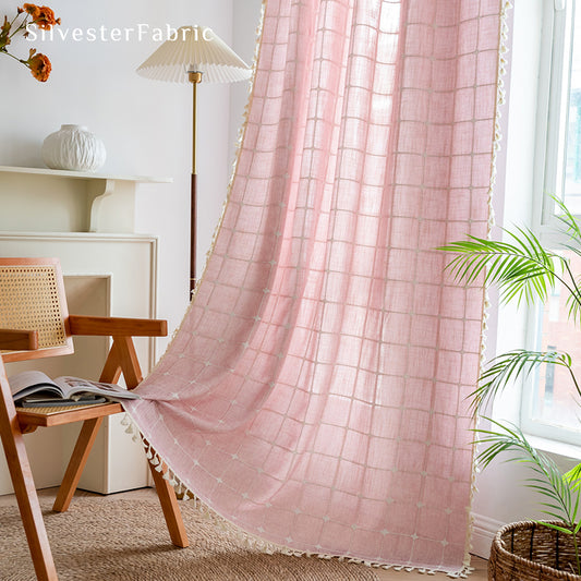 Embroidered plaid light pink curtains hanging in the bedroom window