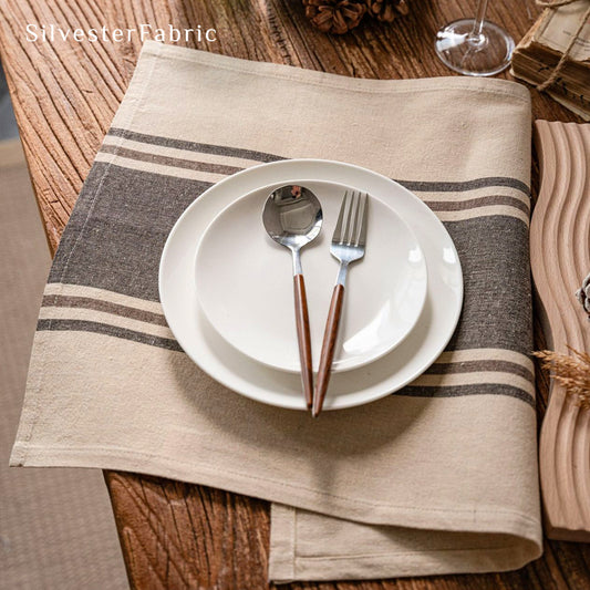 beige striped farmhouse placemats laid flat on dining table