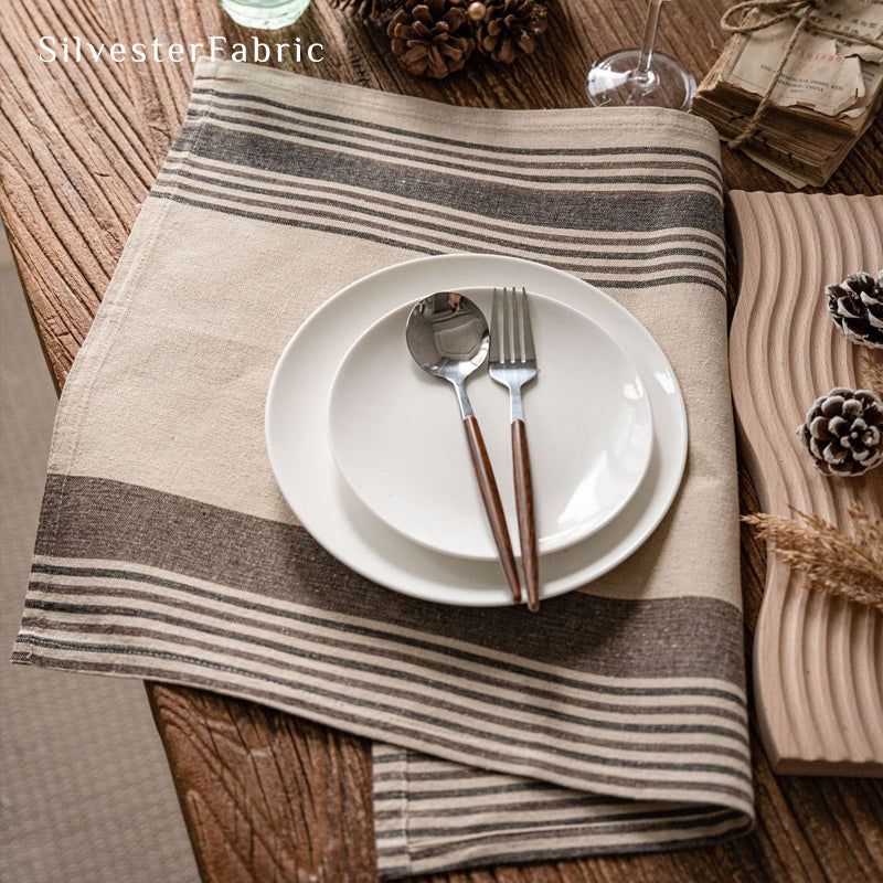 beige farmhouse striped placemats laid flat on dining table