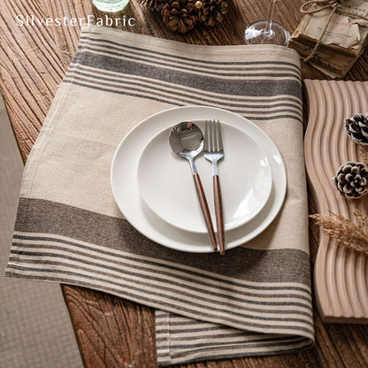 beige farmhouse striped placemats laid flat on dining table