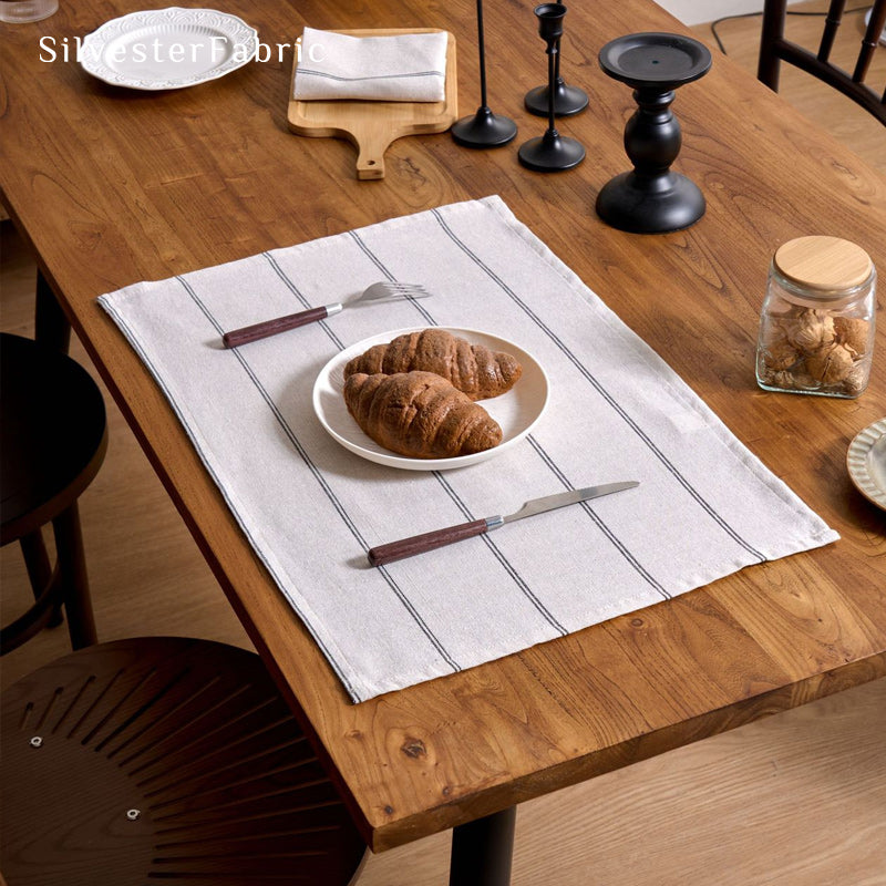 white striped farmhouse placemats laid flat on dining table
